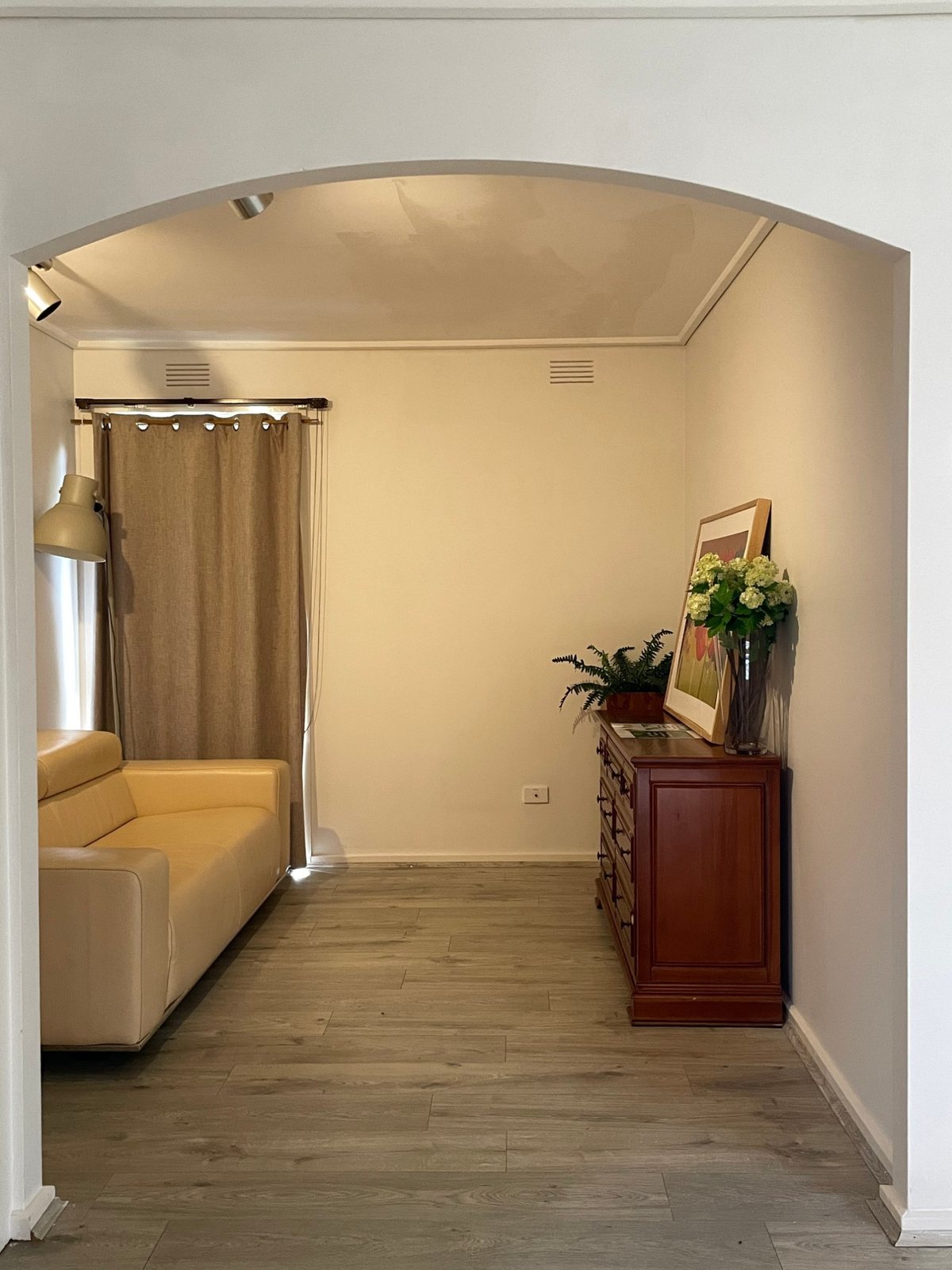 Mono Studio — archway leading to a seating area, with a dresser display in the foreground